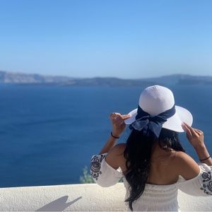 White beach hat with blue ribbon, bought and worn once in Greece!